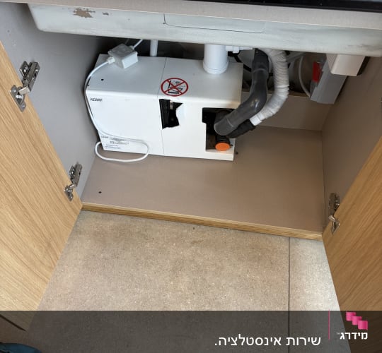 מערכת אינסטלציה מתחת לכיור עם צינורות וחיבורים
